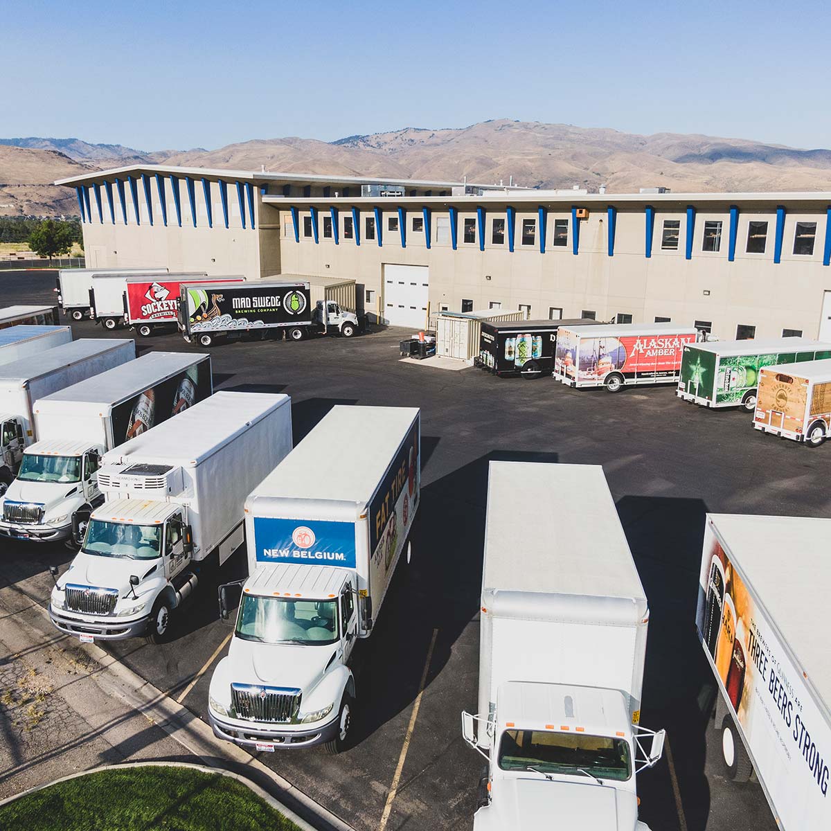 Delivery trucks with warehouse in the background
