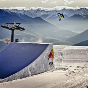 Skier jumping with mountains in background